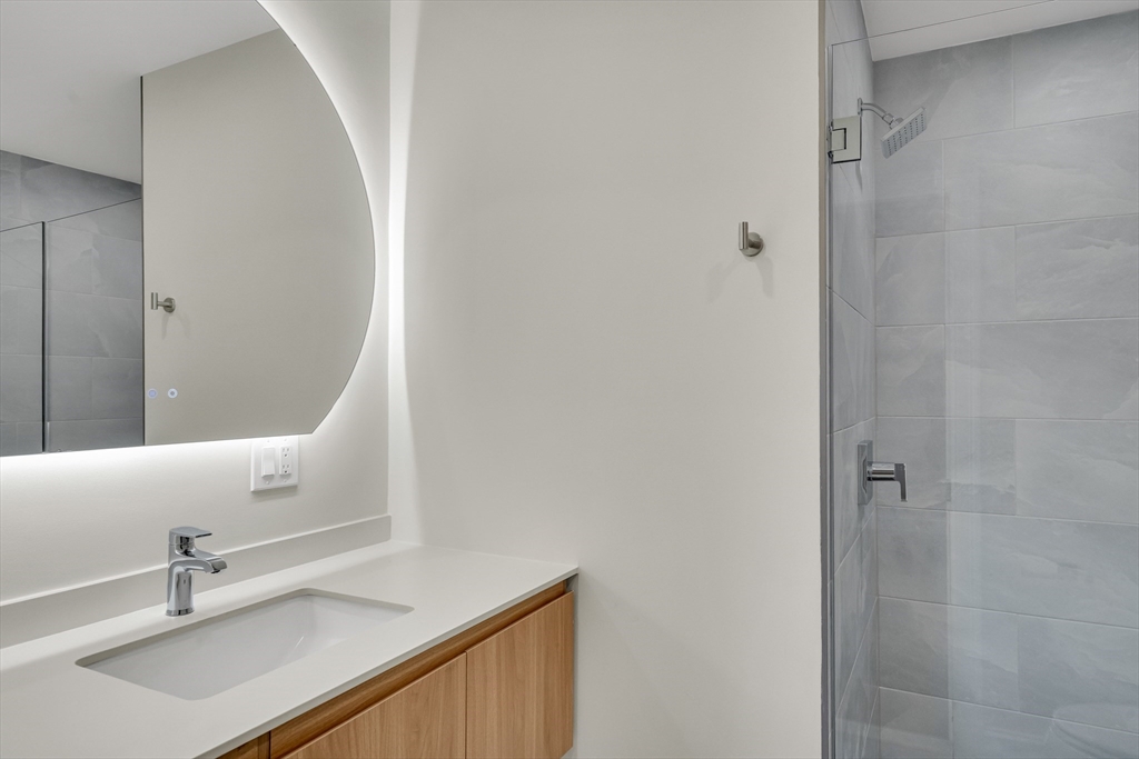 14-16 Summit Street Newton, MA 02458 - Photo 32 of 35 a bathroom with a sink and a mirror