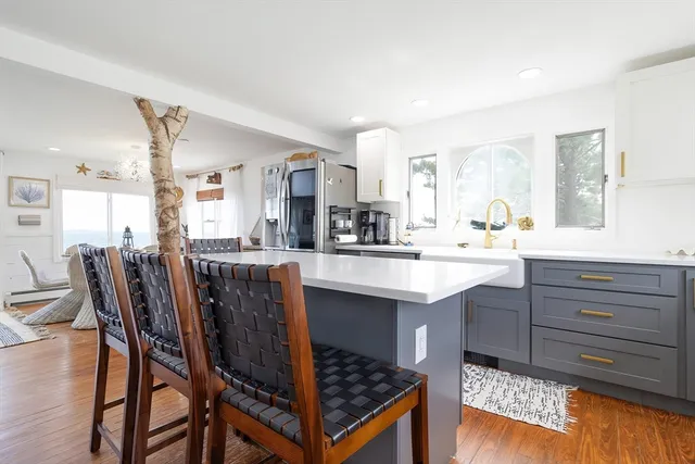 a kitchen with a table chairs sink and cabinets