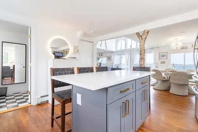 a kitchen with a sink cabinets and wooden floor