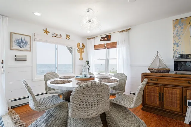 a dining room with furniture and a window