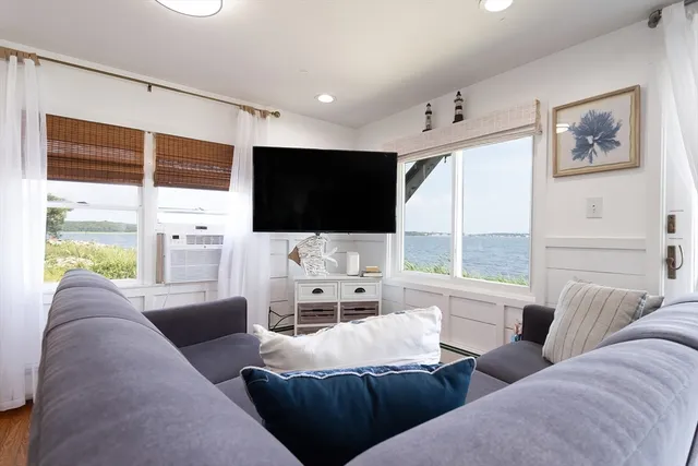 a living room with furniture tv and large window