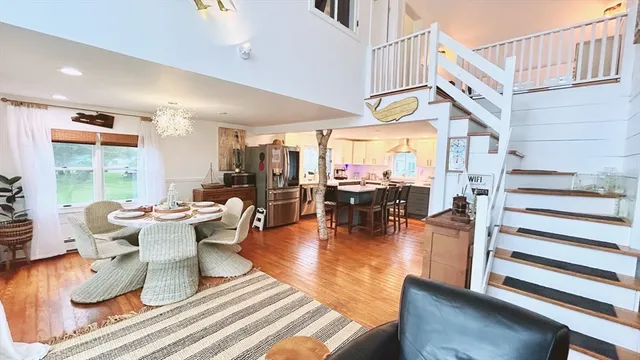 a living room with fireplace furniture and a large window
