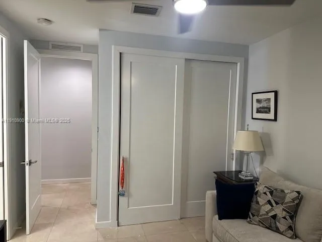 a bedroom with a bed and a lamp