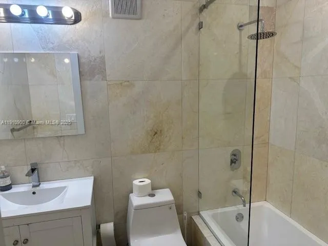 a bathroom with a white bath tub a sink and a toilet