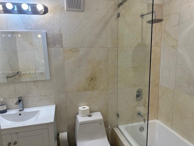 3089 Southwest 21st Street, Unit 3089 Miami, FL 33145 - Photo 9 of 15 a bathroom with a white bath tub a sink and a toilet