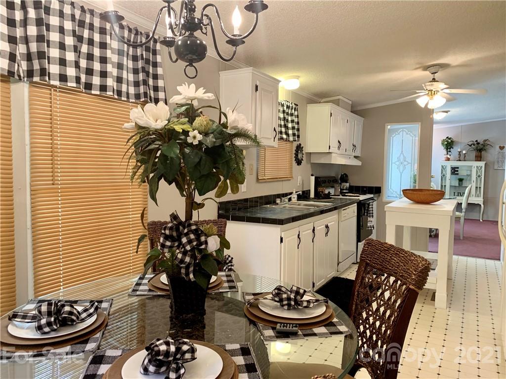 1495 Stanton Loop Road Purlear, NC 28665 - Photo 22 of 43 a kitchen with a table and chairs in it