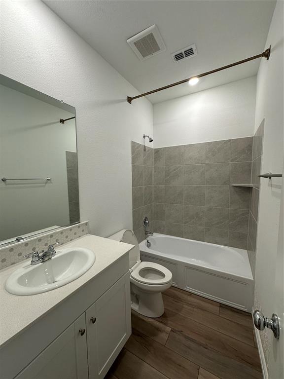 1462 Everett Gdns Way Forney, TX 75126 - Photo 12 of 14 Full bathroom featuring tub / shower combination, vanity, and dark wood-type flooring