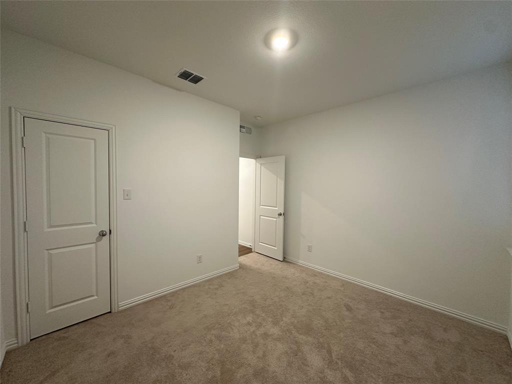 1462 Everett Gdns Way Forney, TX 75126 - Photo 3 of 14 Unfurnished bedroom featuring baseboards and carpet floors