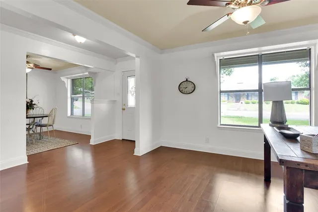 a workspace with wooden floor and a window