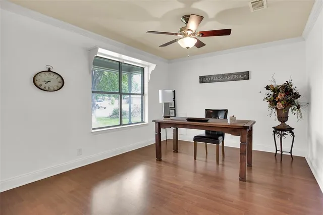 a view of a workspace with furniture window and wooden floor