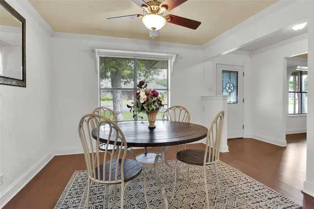 a dining room with furniture and wooden floor