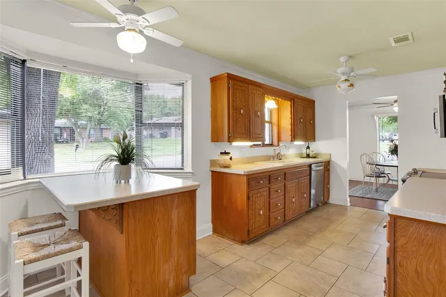 a kitchen with a sink appliances and cabinets