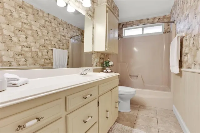 a bathroom with a double vanity sink toilet and shower