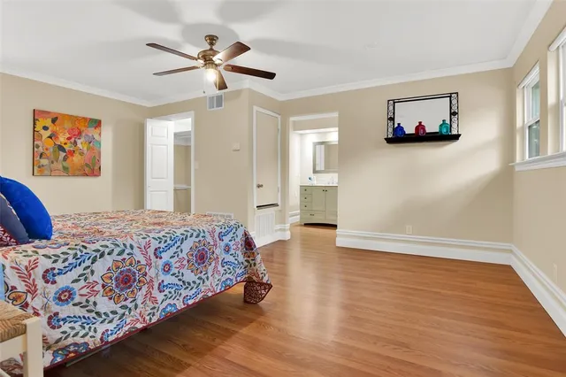 a bedroom with a large bed and a chandelier