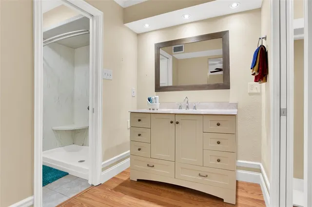 a bathroom with a granite countertop sink mirror and