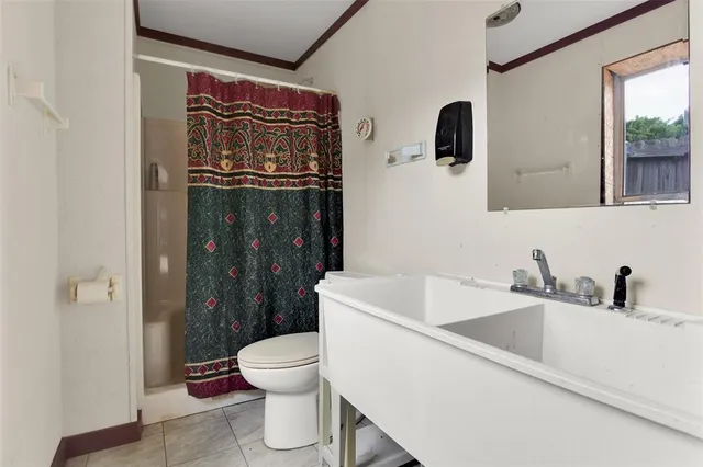 a bathroom with a toilet sink and shower