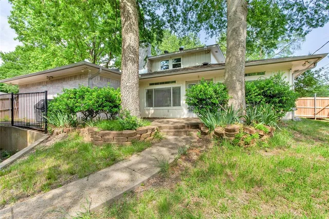 a front view of a house with garden