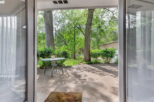 a view of a porch with chairs and backyard