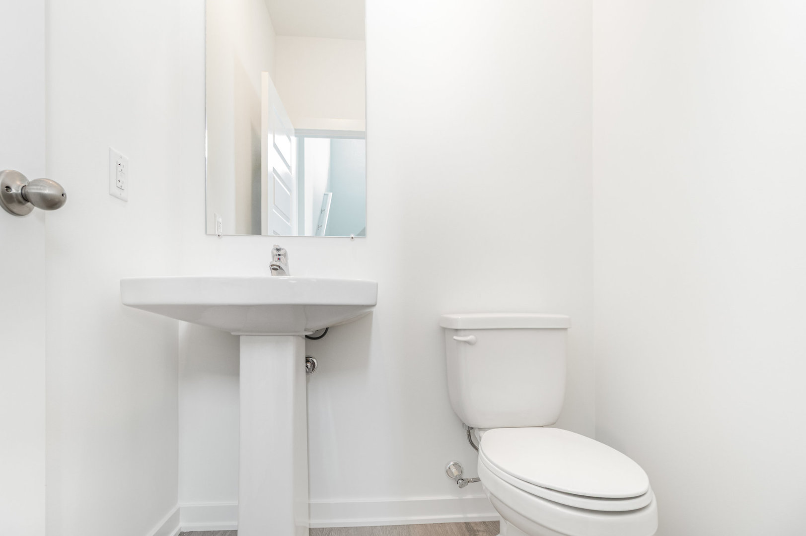 2171 Yellowstone Boulevard, Unit 2171 Mundelein, IL 60060 - Photo 4 of 23 a white toilet sitting next to a bathroom sink