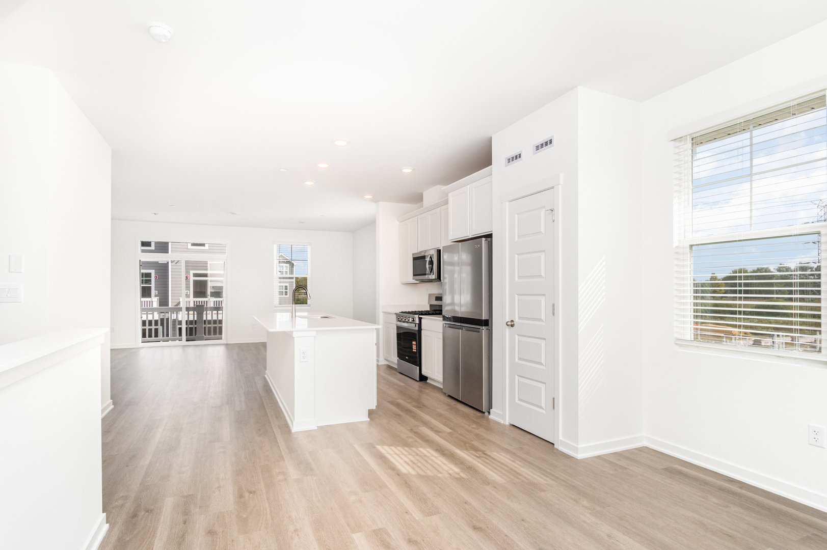 2171 Yellowstone Boulevard, Unit 2171 Mundelein, IL 60060 - Photo 6 of 23 a view of a kitchen with refrigerator and wooden floor