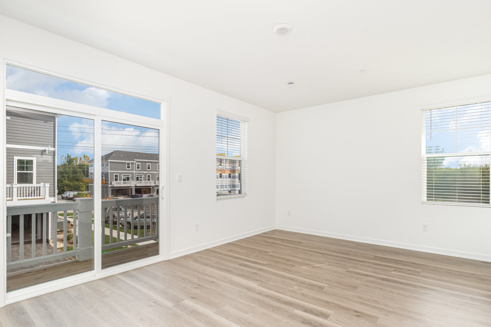 2171 Yellowstone Boulevard, Unit 2171 Mundelein, IL 60060 - Photo 9 of 23 a view of an empty room with window and wooden floor