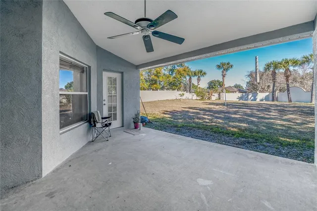 a view of livingroom with furniture ceiling fan and window