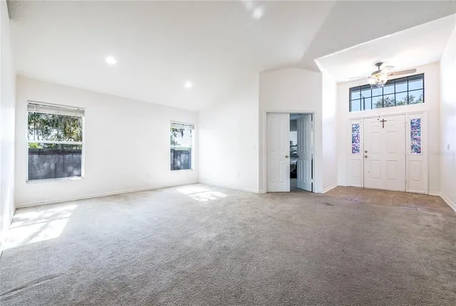 an empty room with windows and closet