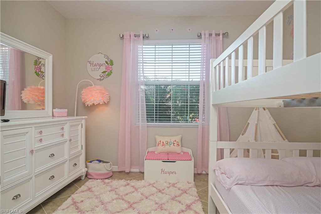 2076 Hamlin Street Naples, FL 34120 - Photo 12 of 24 a bedroom with a bed and wooden floor