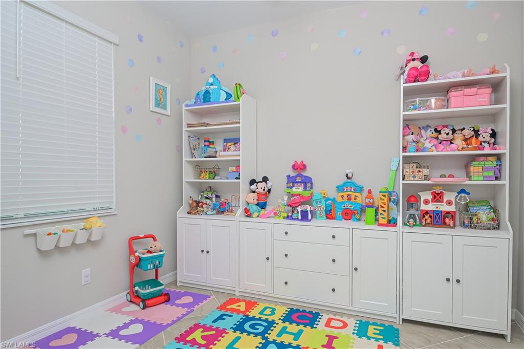 2076 Hamlin Street Naples, FL 34120 - Photo 13 of 24 a room with toys and a wooden floor