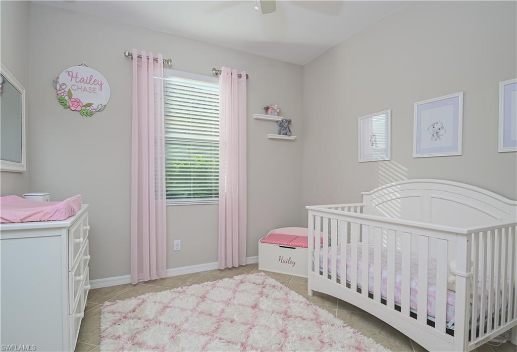 2076 Hamlin Street Naples, FL 34120 - Photo 15 of 24 a bedroom with a bed and a window