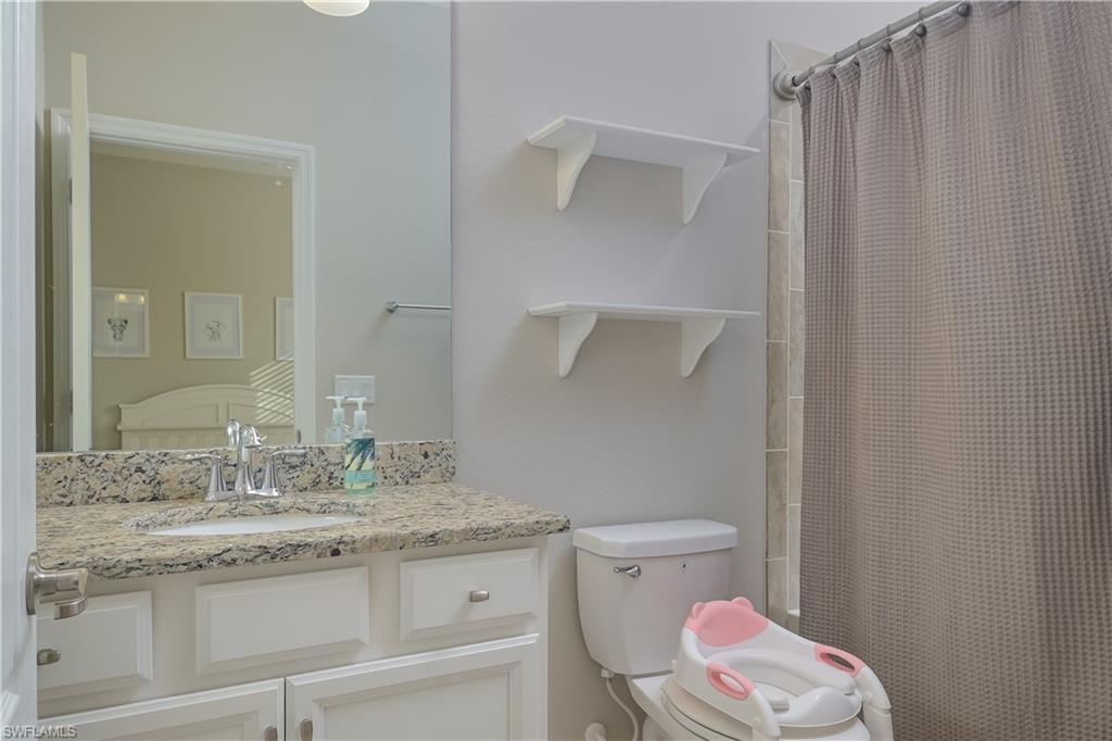 2076 Hamlin Street Naples, FL 34120 - Photo 16 of 24 a bathroom with a granite countertop sink toilet and shower