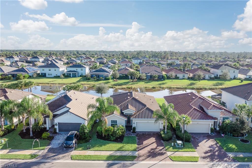 2076 Hamlin Street Naples, FL 34120 - Photo 22 of 24 an aerial view of residential houses with outdoor space and lake view