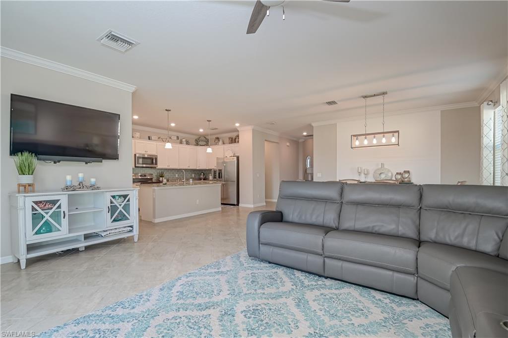 2076 Hamlin Street Naples, FL 34120 - Photo 5 of 24 a living room with furniture and a flat screen tv