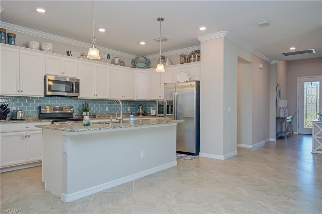 2076 Hamlin Street Naples, FL 34120 - Photo 6 of 24 a kitchen with stainless steel appliances granite countertop a refrigerator and a stove top oven
