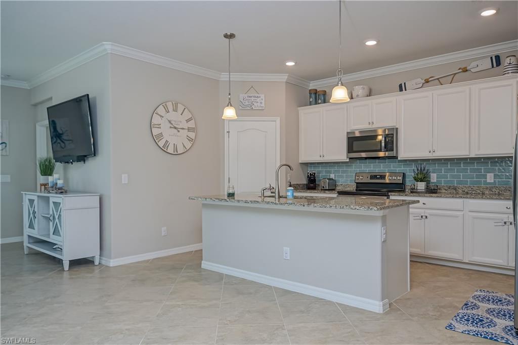 2076 Hamlin Street Naples, FL 34120 - Photo 8 of 24 a kitchen with a sink cabinets and window