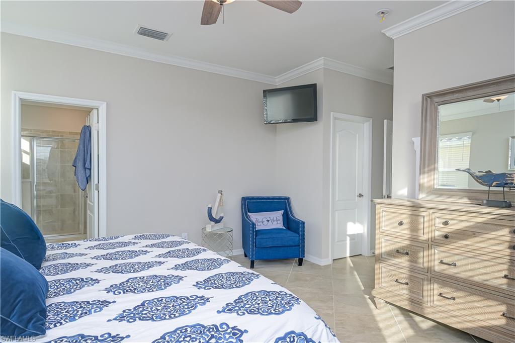 2076 Hamlin Street Naples, FL 34120 - Photo 10 of 24 a bedroom with a bed and a television
