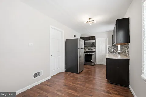 a view of kitchen with refrigerator and window