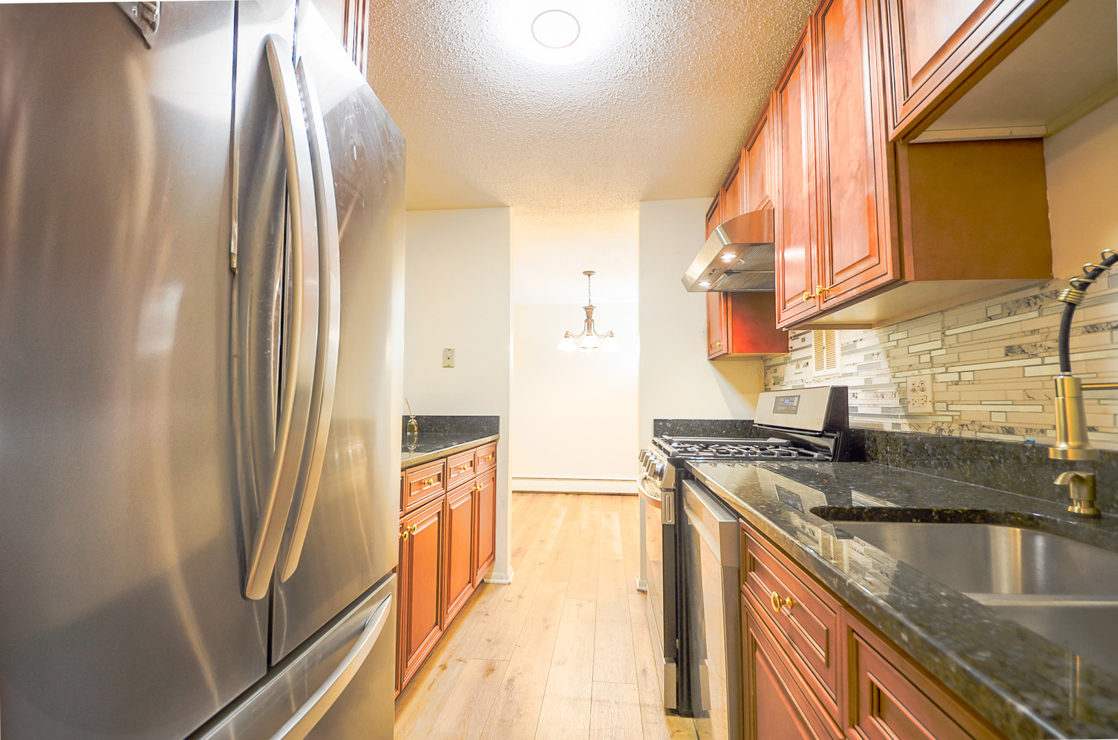 1206 South New Wilke Road, Unit 108 Arlington Heights, IL 60005 - Photo 9 of 21 a kitchen with stainless steel appliances granite countertop a refrigerator and a sink
