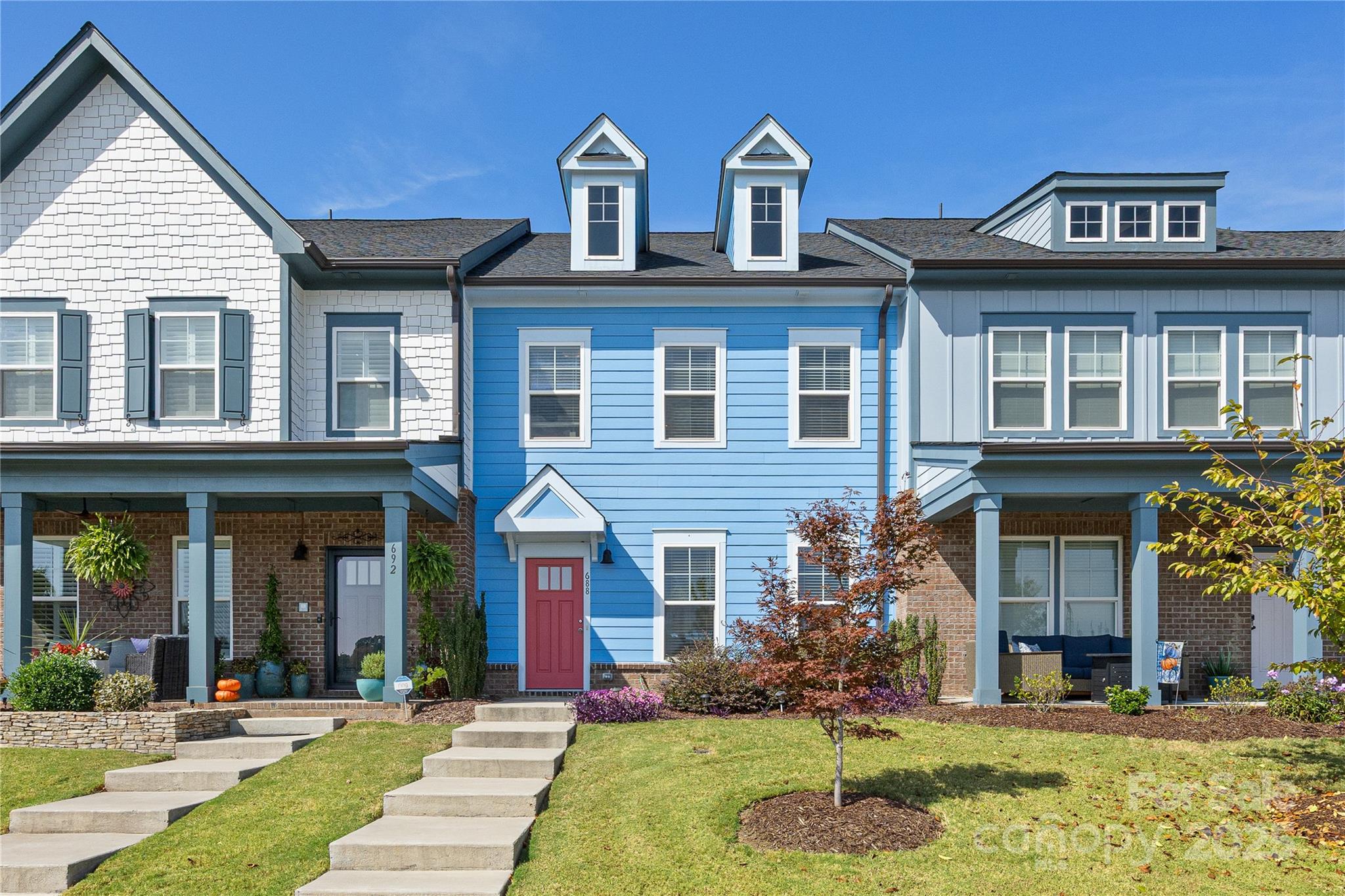 front view of residential houses with a yard