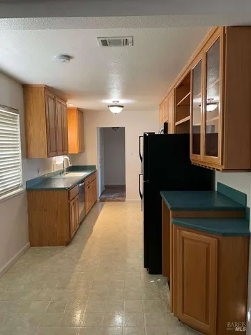 a kitchen with stainless steel appliances granite countertop a refrigerator and a stove