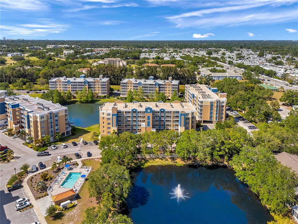 960 Starkey Road, Unit 1503 Largo, FL 33771 - Photo 1 of 1 a view of a city with lots of residential buildings ocean and mountain view