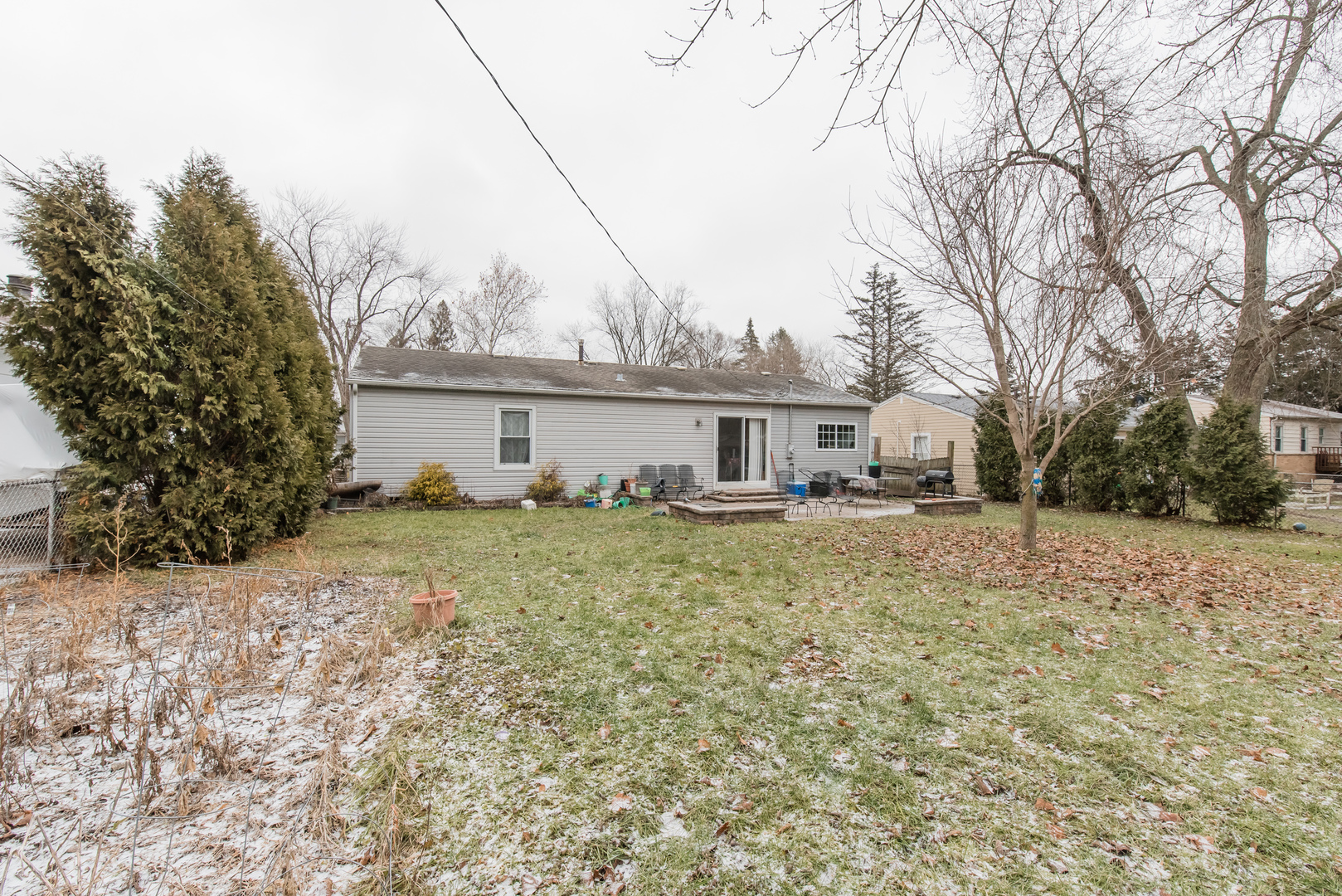 227 Rivers View Drive Carpentersville, IL 60110 - Photo 24 of 24 a front view of a house with a yard covered in snow