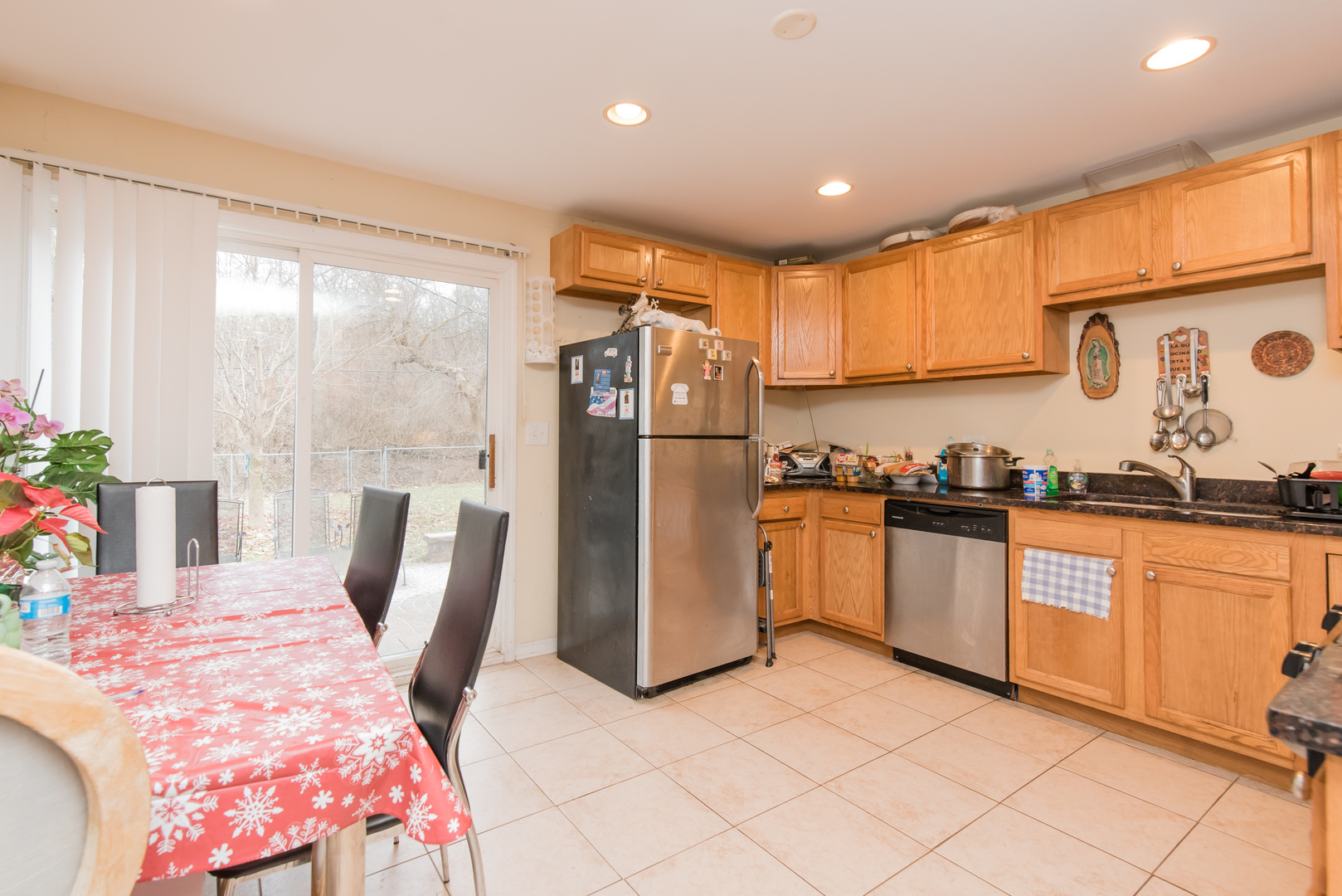 227 Rivers View Drive Carpentersville, IL 60110 - Photo 9 of 24 a kitchen with stainless steel appliances granite countertop a refrigerator a sink dishwasher a stove with white cabinets and wooden floor