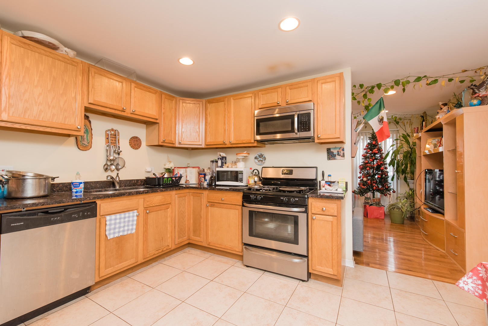 227 Rivers View Drive Carpentersville, IL 60110 - Photo 10 of 24 a kitchen with stainless steel appliances granite countertop a stove top oven a sink dishwasher and a microwave oven on the blue kitchen countertops