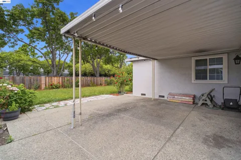 a view of a house with backyard and sitting area