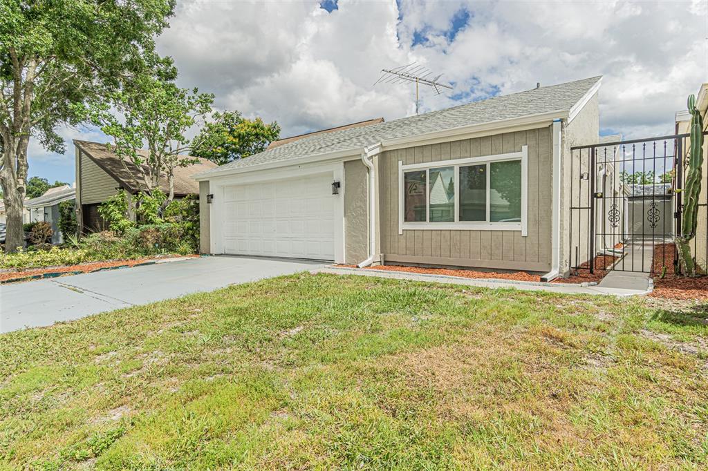 a view of house with backyard space and garden