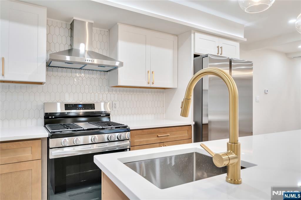 468 Morse Avenue Ridgefield, NJ 07657 - Photo 12 of 48 a kitchen with stainless steel appliances granite countertop a sink a stove and a wooden floors
