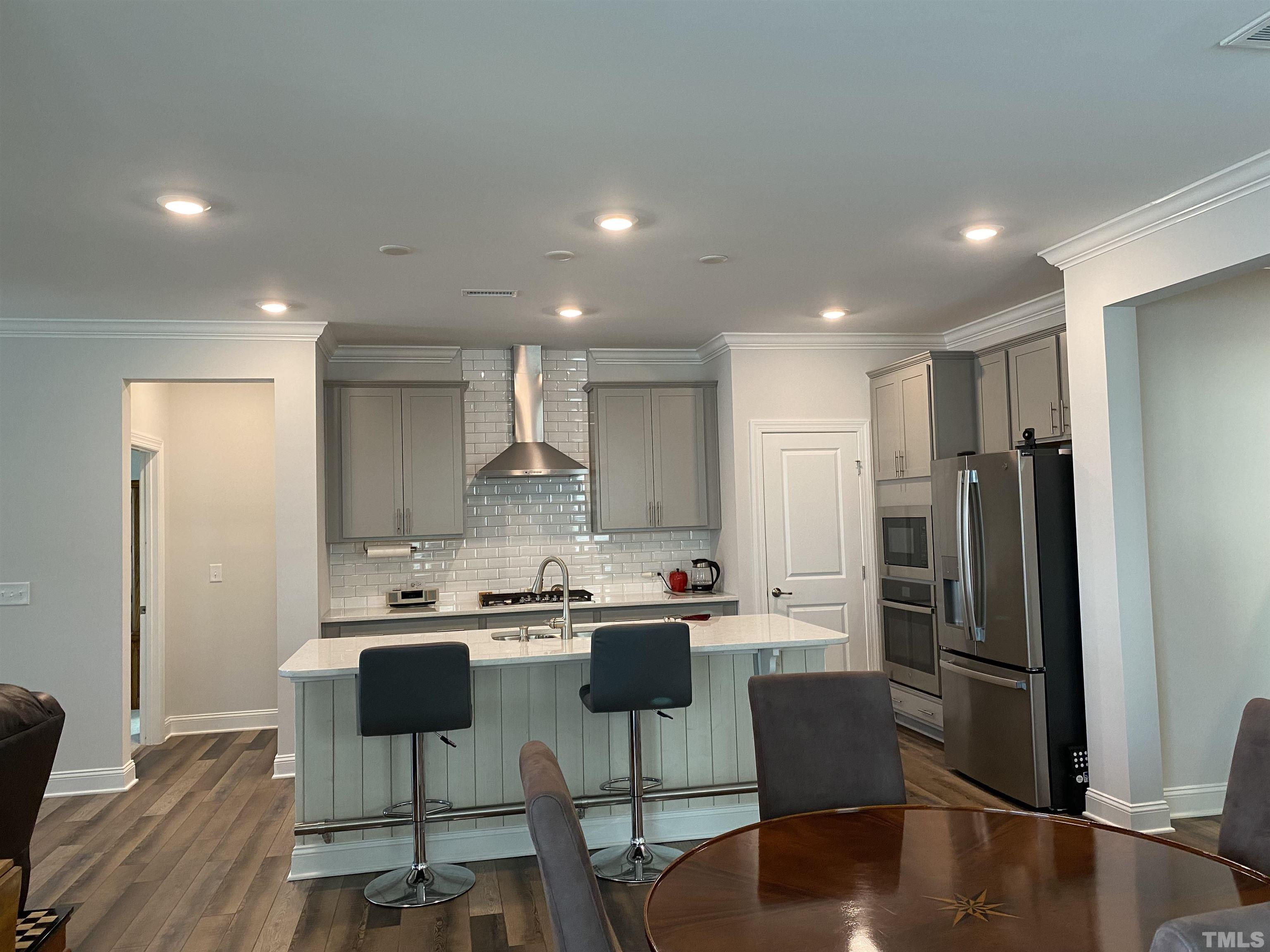 107 Ivory Lane Raleigh, NC 27610 - Photo 2 of 25 a kitchen with stainless steel appliances granite countertop a refrigerator a stove a sink a dining table and chairs