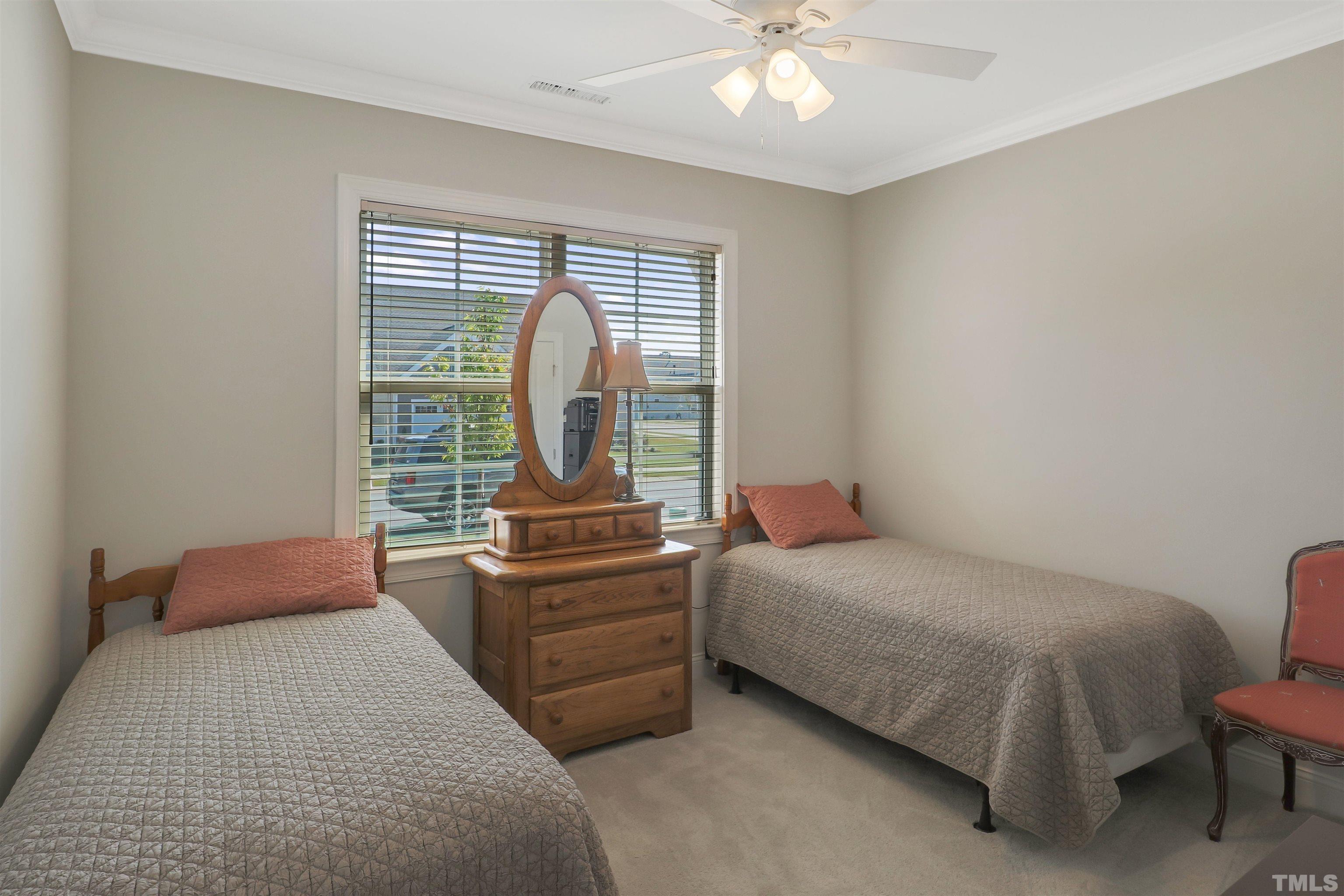107 Ivory Lane Raleigh, NC 27610 - Photo 17 of 25 a room with a bed and a chandelier