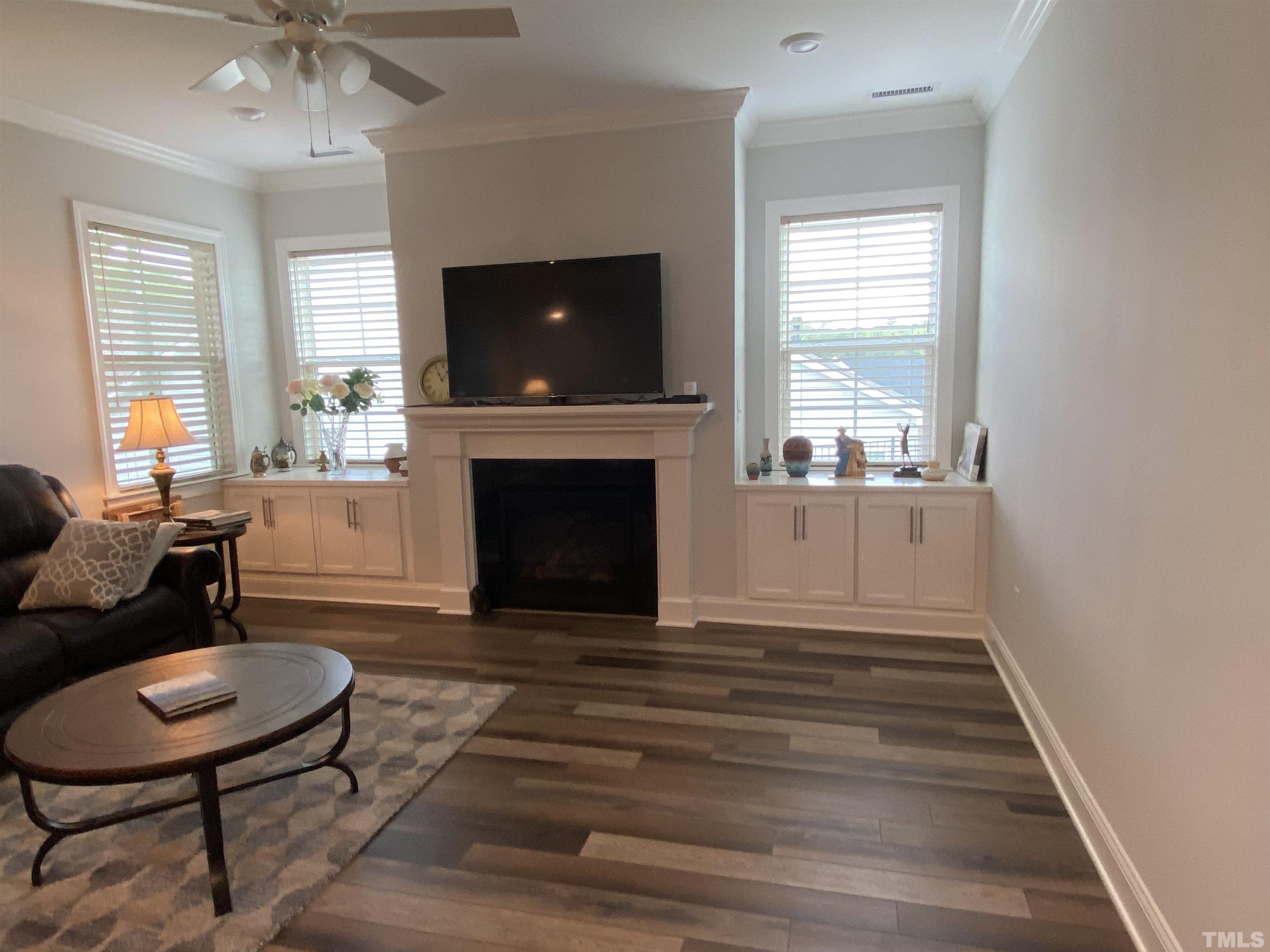 107 Ivory Lane Raleigh, NC 27610 - Photo 3 of 25 a living room with furniture a flat screen tv and a fireplace